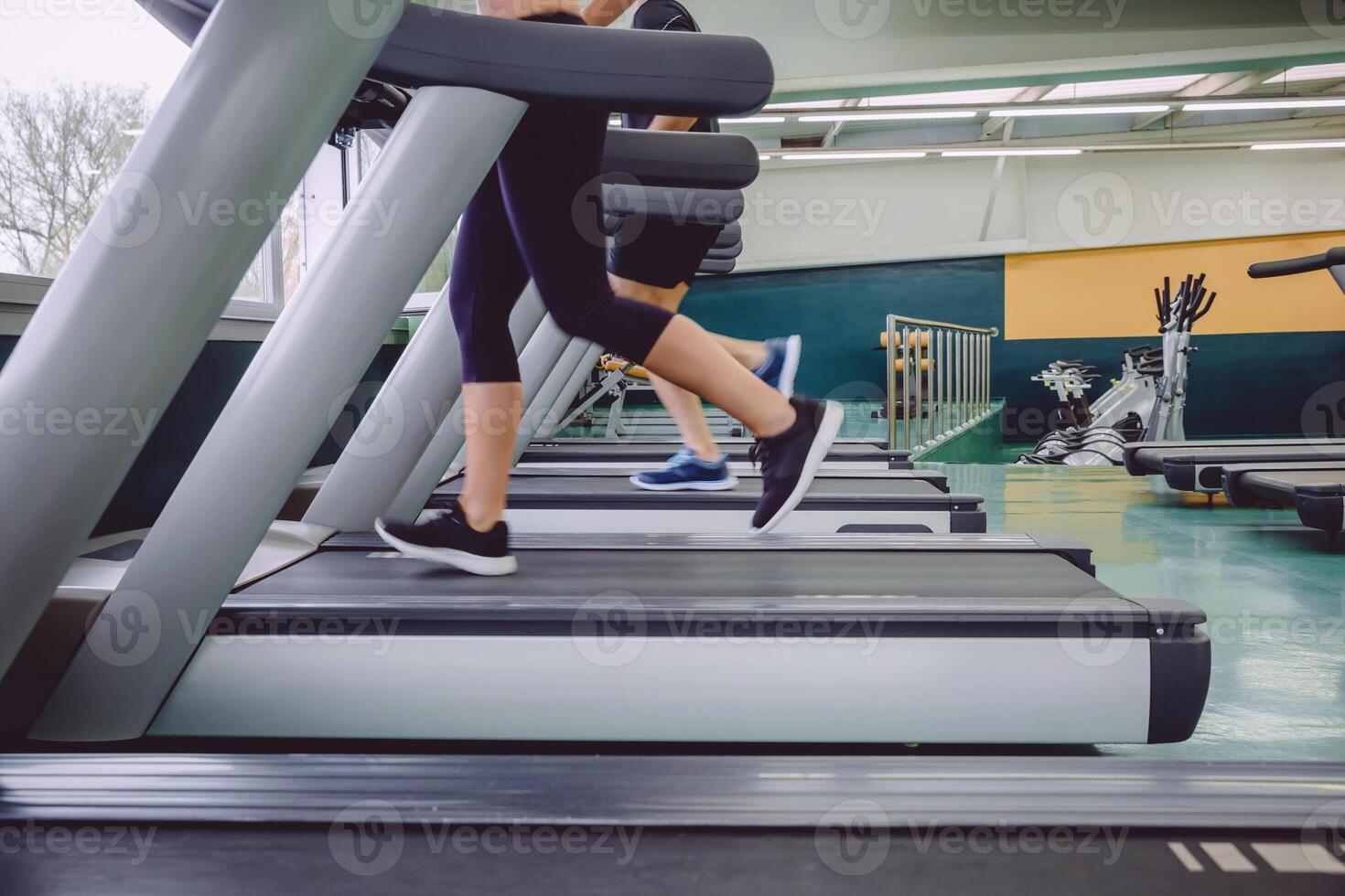 People legs running over treadmill in training session photo