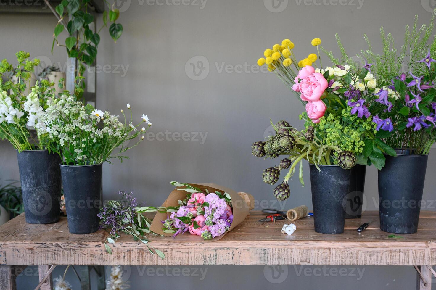 Potted colorful flowers on wooden table photo