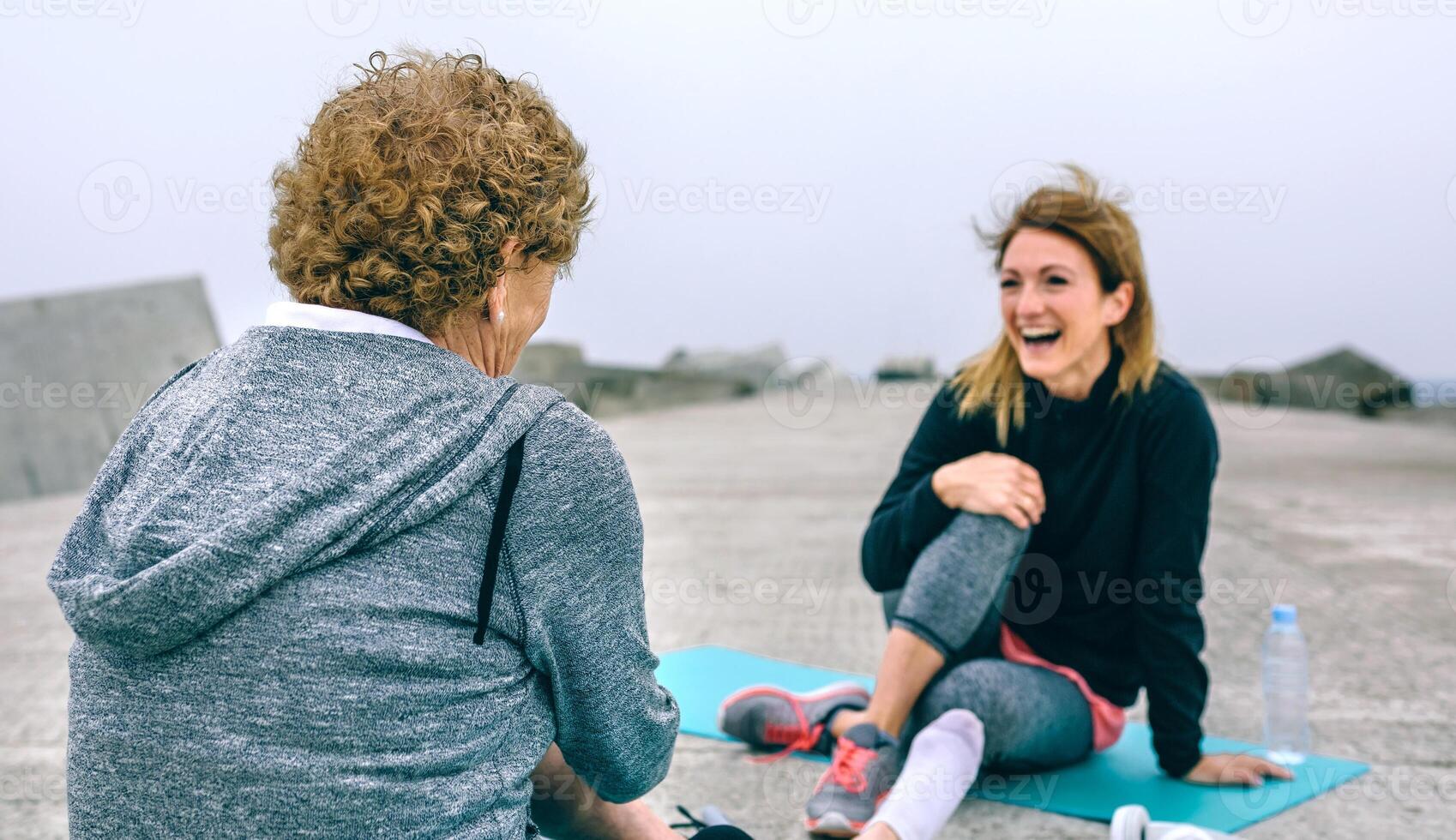 Sportswoman laughing with senior woman photo