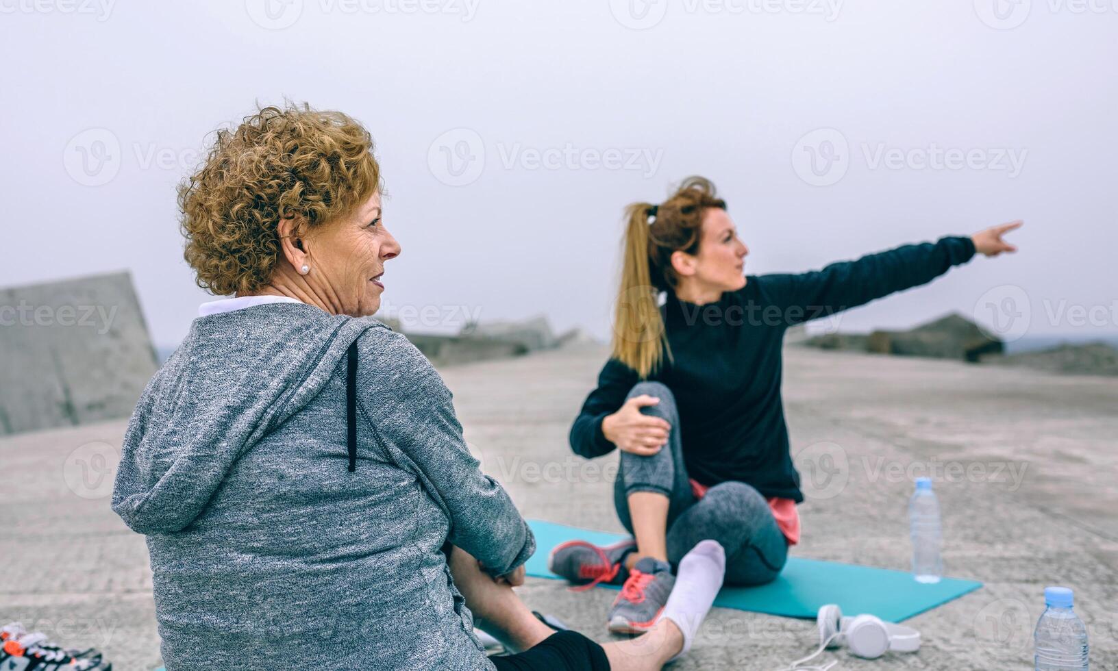 Senior sportswoman with woman pointing photo