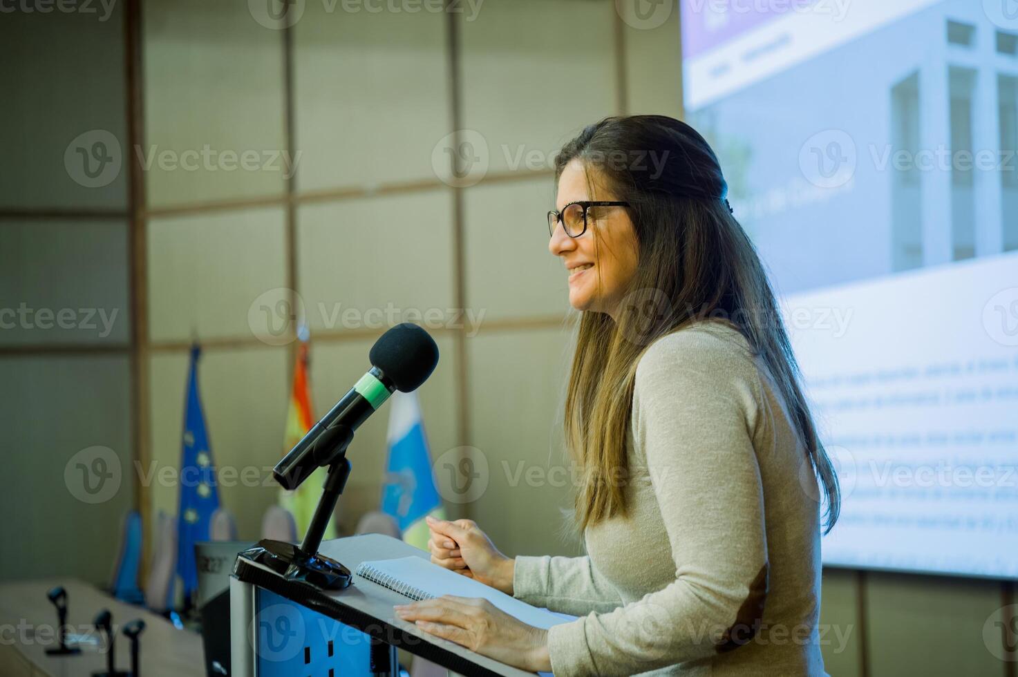 Smiling woman giving lecture in university photo