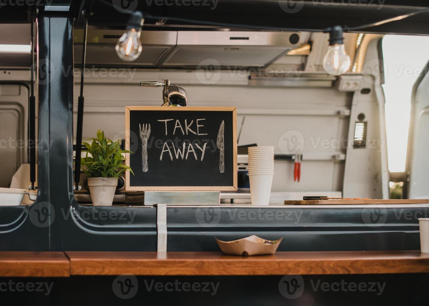 Food truck burger van outdoor in city park - Main focus on chalkboard take away sign photo