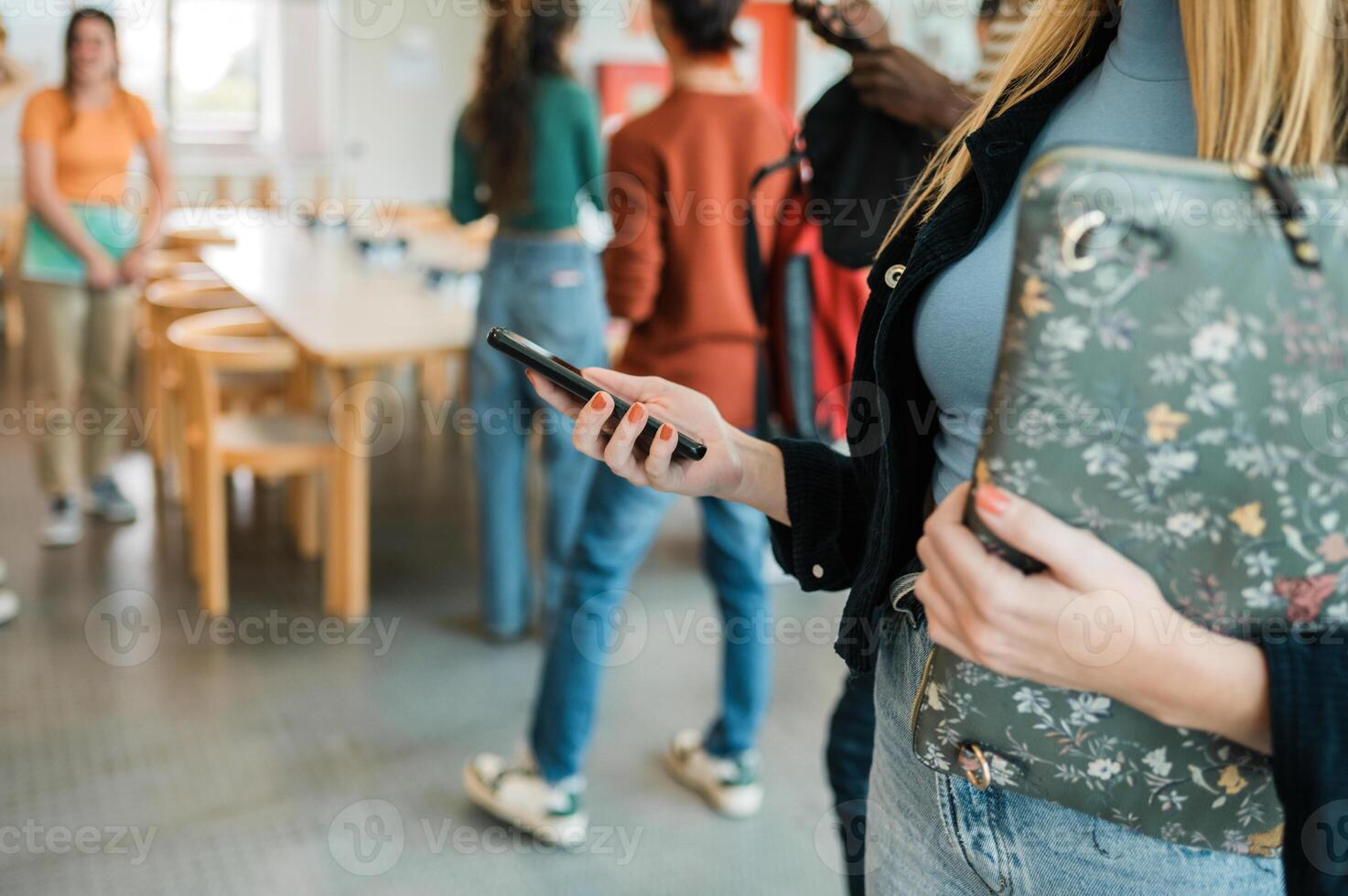 Crop student using smartphone before lesson photo
