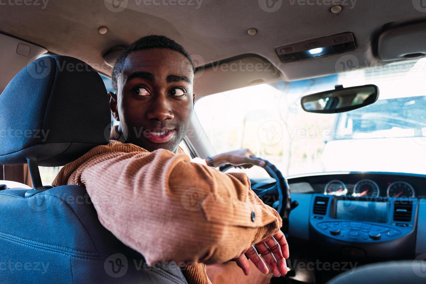 Black driver reversing with in the car photo