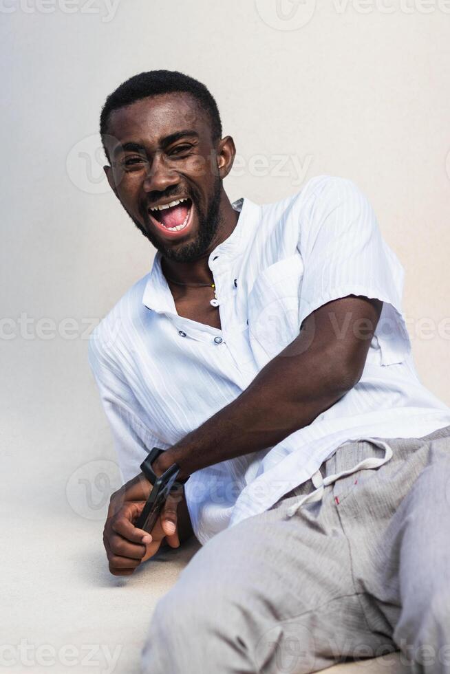 Optimistic black man laughing at camera photo