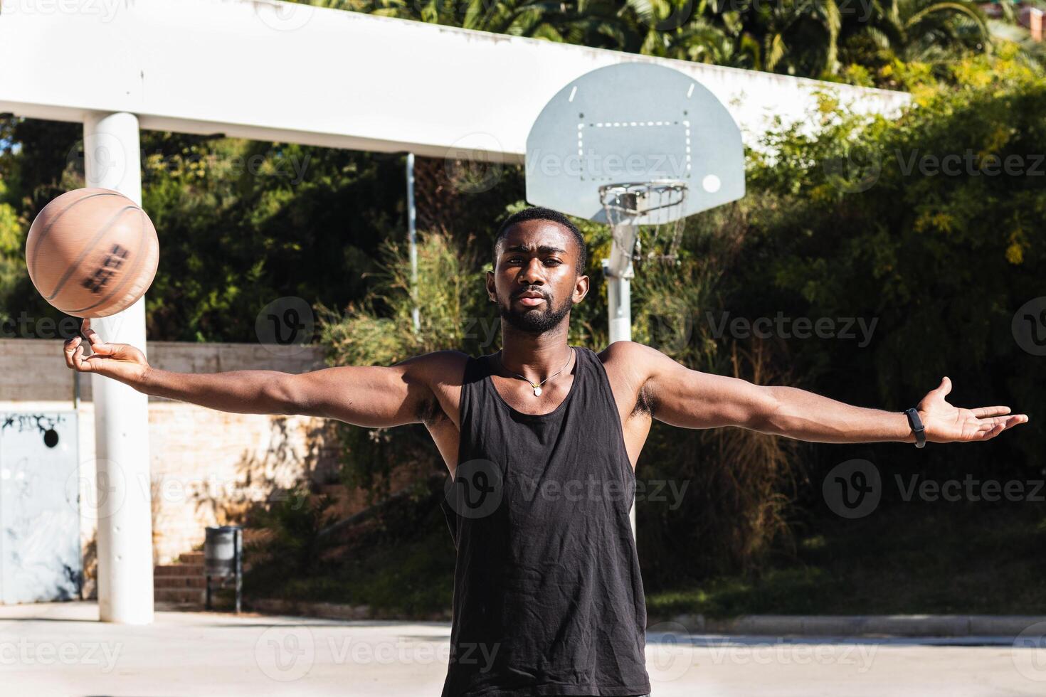 Ethnic basketball player spinning ball on finger photo