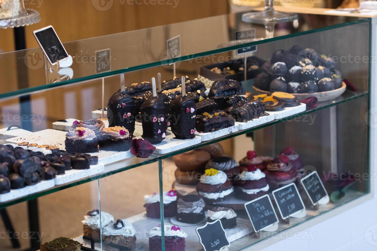 Various desserts on showcase in bakery photo