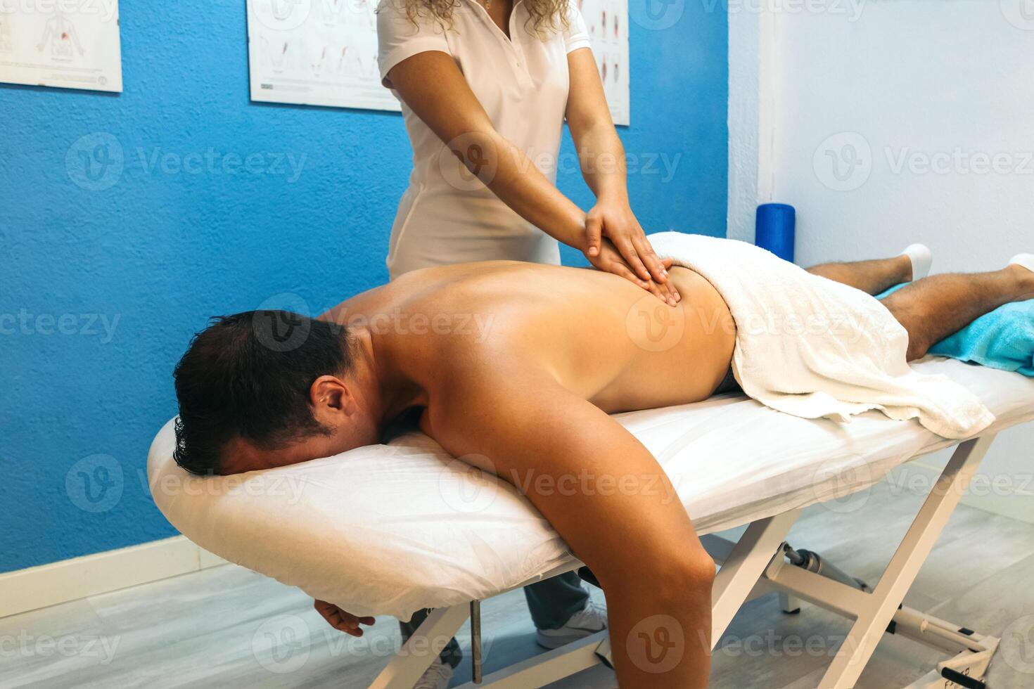 physiotherapist treating a patient's lower back. photo