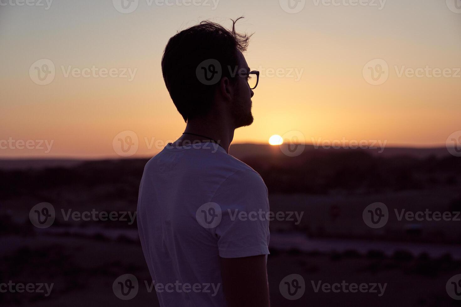Man admiring sunset in nature photo