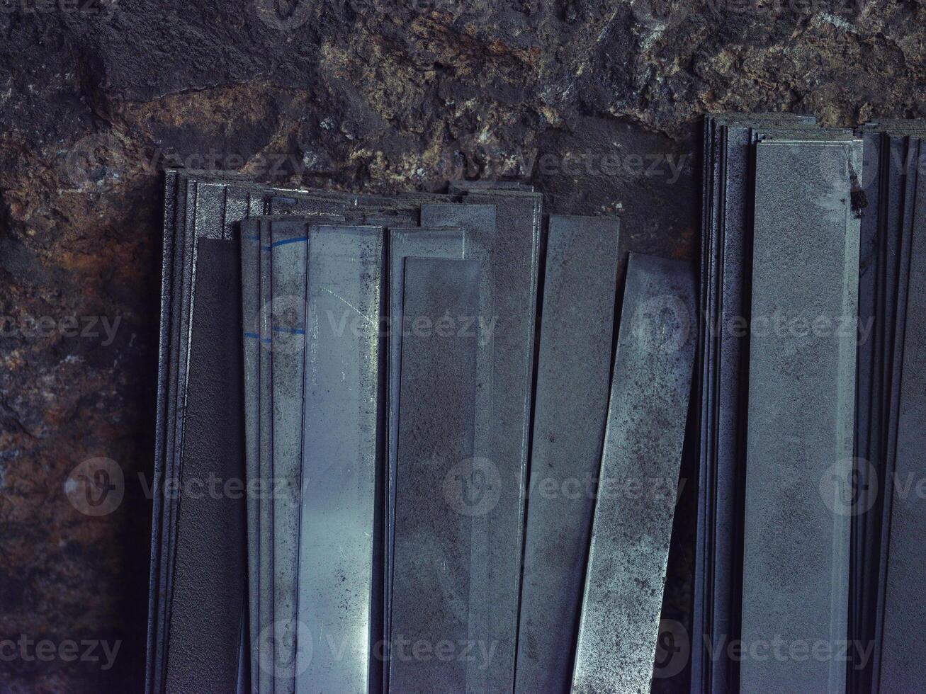 Bunch of metal sheets in forge workshop photo