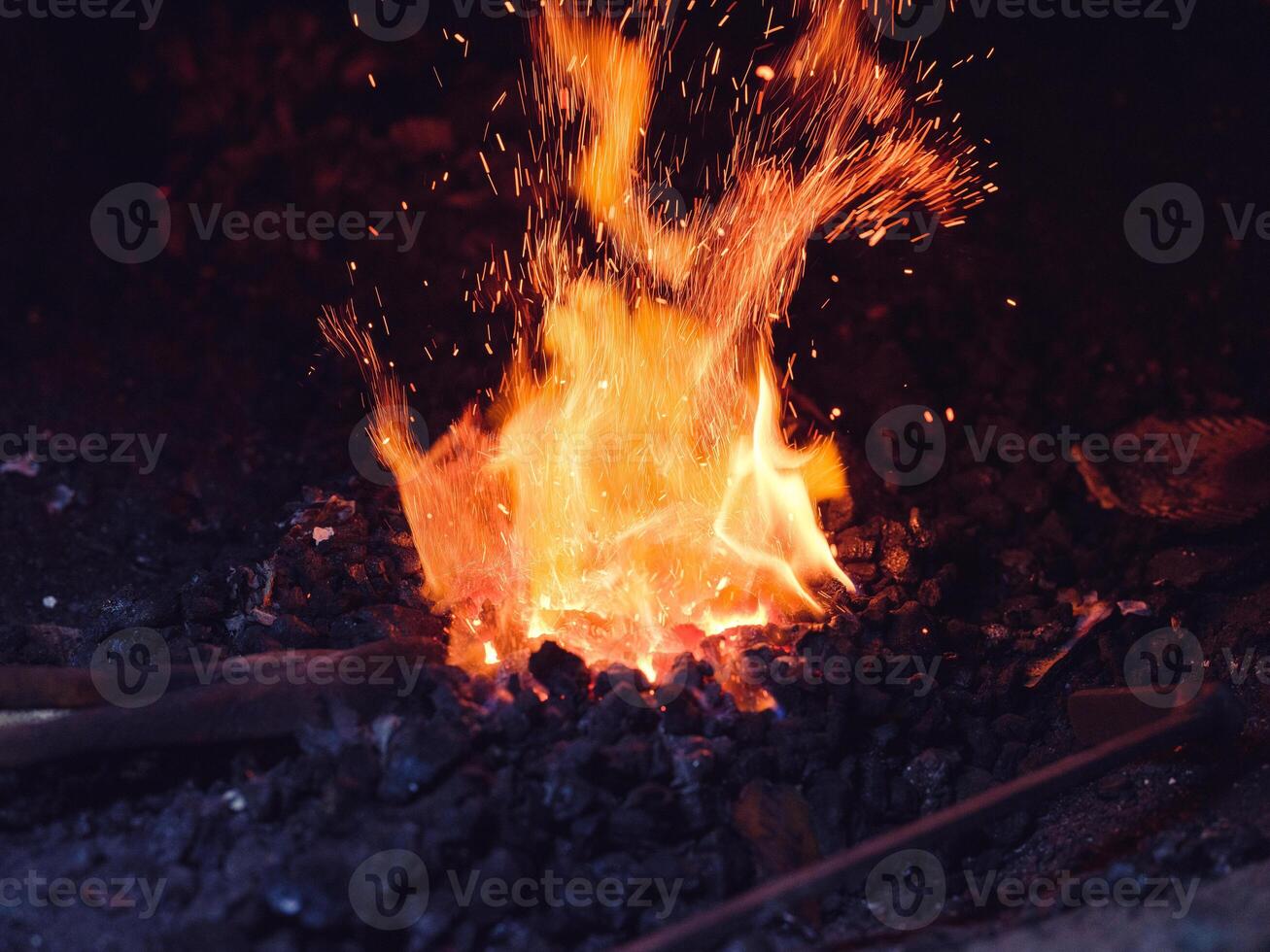 Metal being heated in furnace in workshop photo