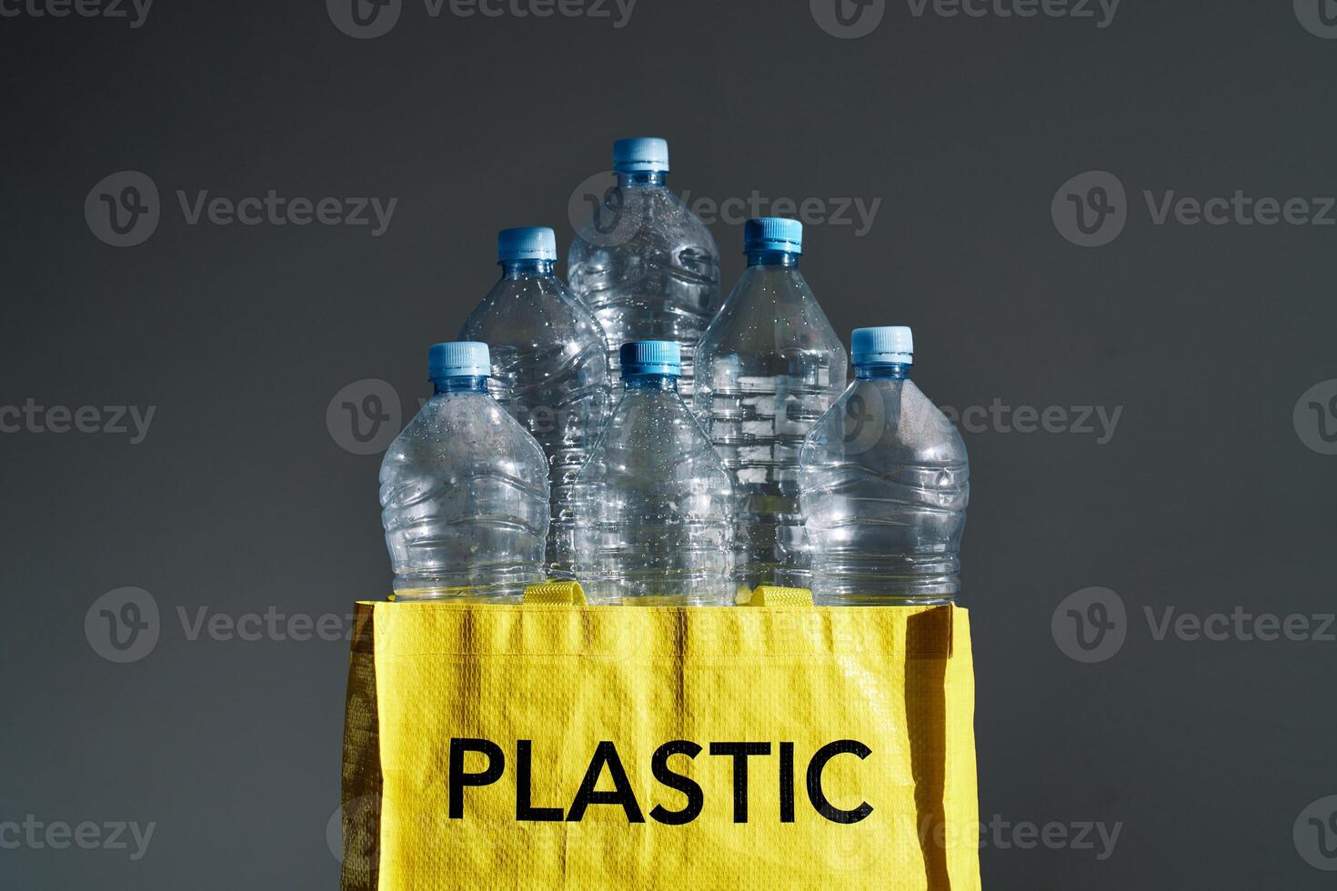 Plastic bottles in yellow bag for recycling photo