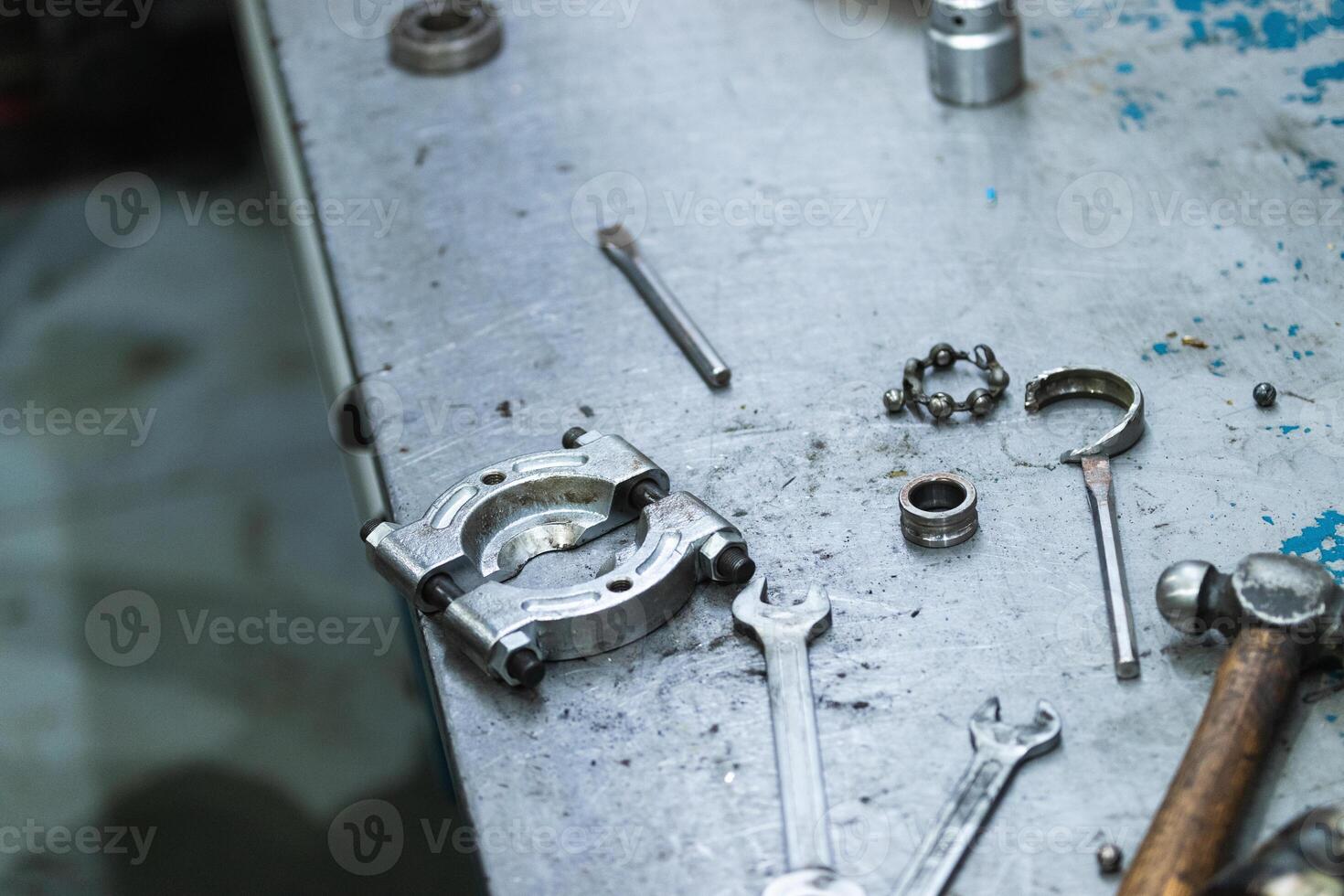 Various repair tools arranged on table in workshop photo