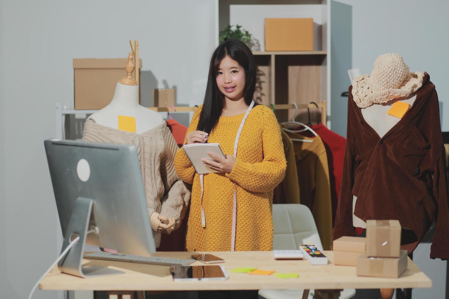 A woman is standing in front of a computer photo