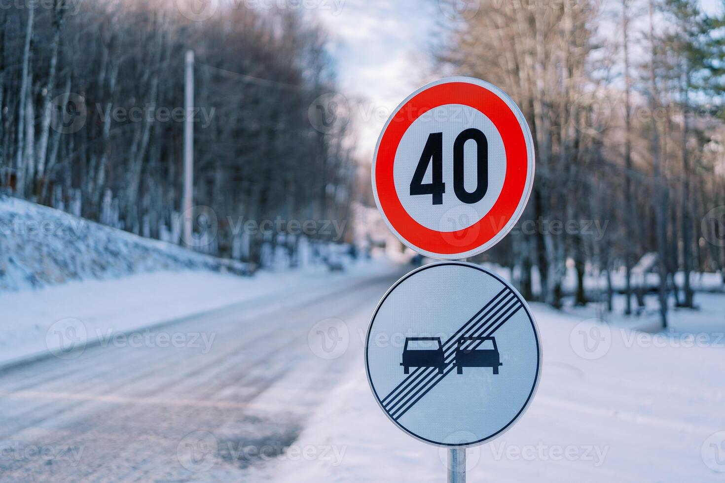 Road sign with speed limit on a snowy road in the park. Caption. 40 photo