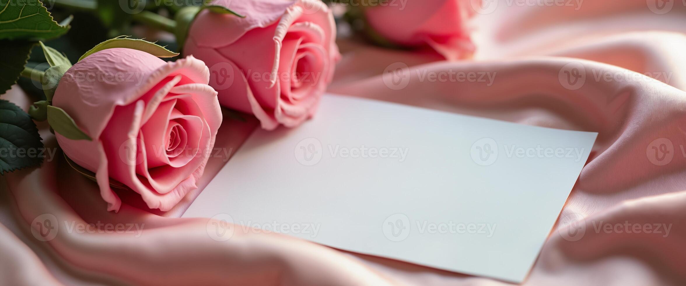 Elegant pink roses on silk with blank card for romantic greetings photo