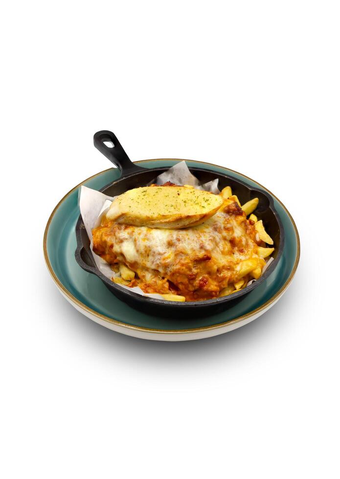 Baked dish with fries and cheese with a side of bread photo