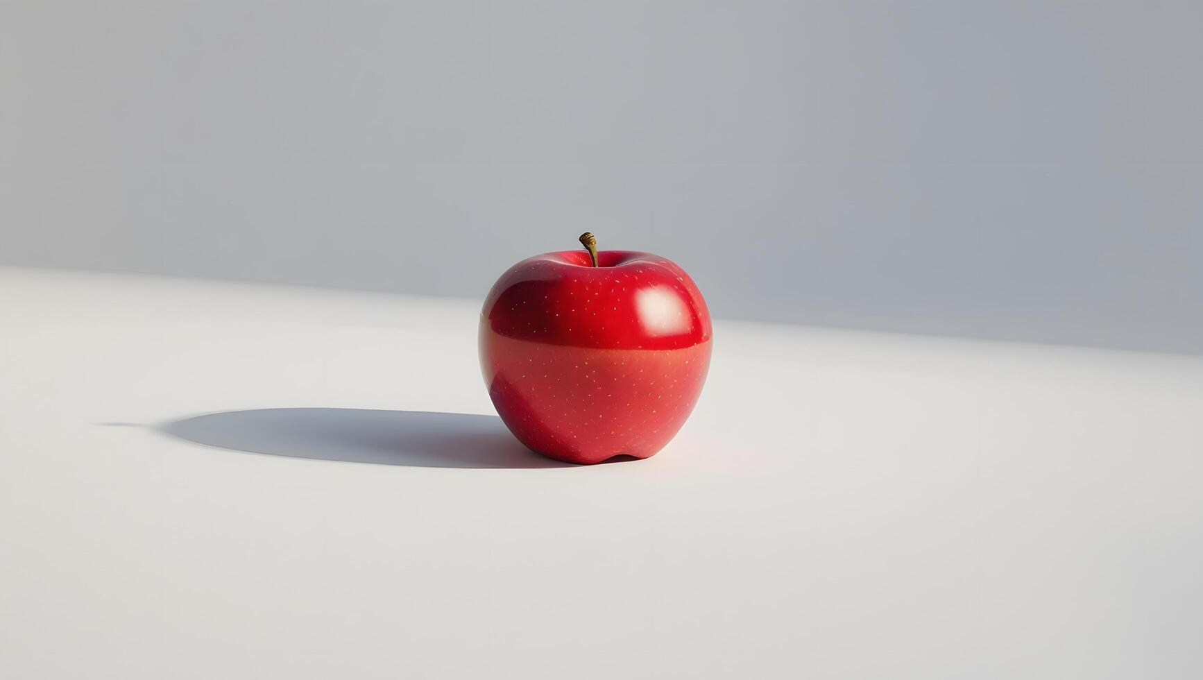 A red apple sitting on a white surface photo