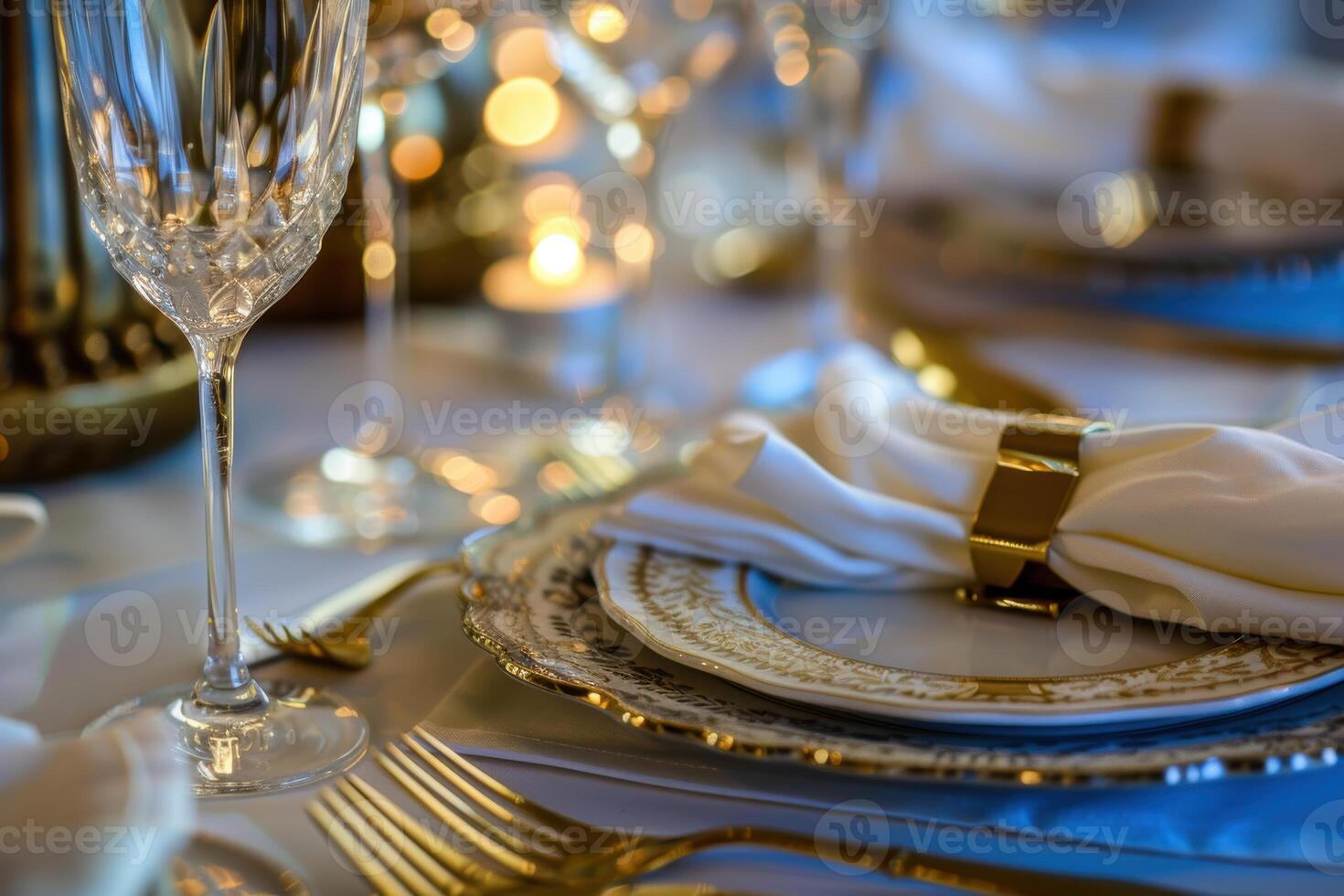 Elegant Fine Dining Table Setting with Gold Cutlery and Crystal Glassware for Luxurious Ambiance photo