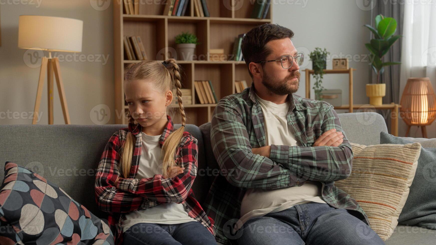 Frustrated Caucasian parent dad male talking family guy daughter arguing at home angry child crossing arms father kid turning away little girl man avoid each other trouble psychology conflict indoors photo
