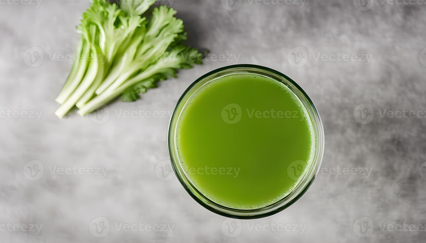 Overhead closeup of a glass of fresh celery juice photo