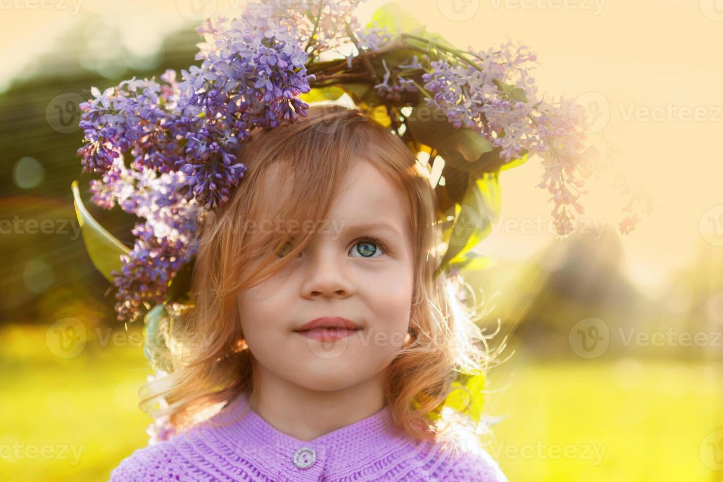 Little girl in spring lilac garland photo