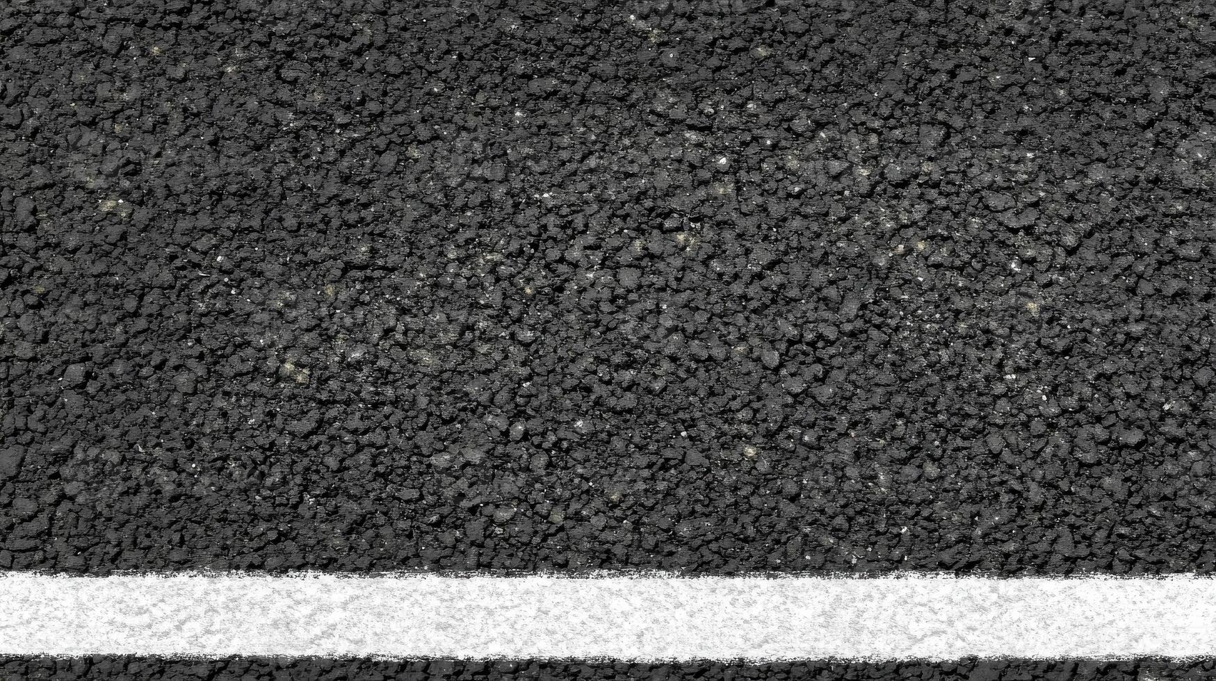 Close-up of asphalt road with single white line texture concept photo
