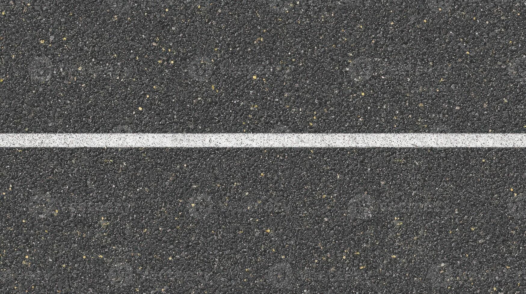 Close-up of asphalt texture with white line for road and construction concepts photo