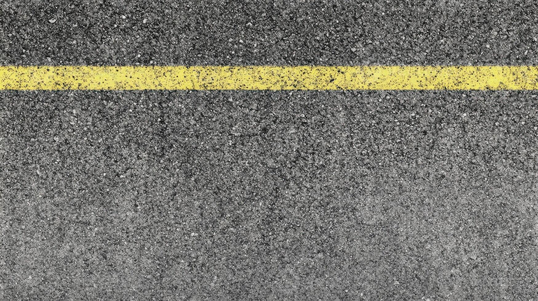 Close-up of asphalt road surface with yellow line for traffic guidance concept photo
