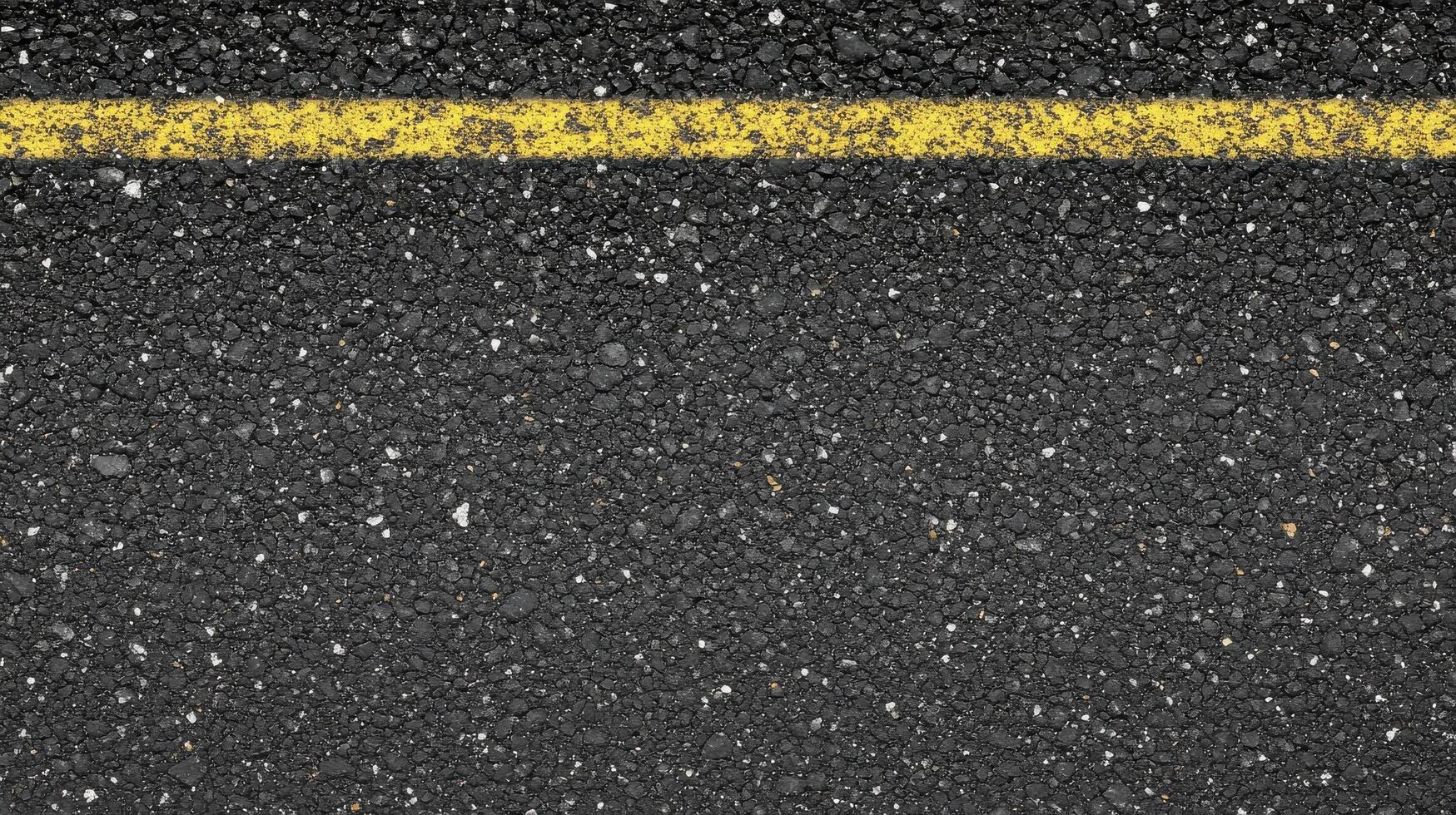 Close-up of asphalt road surface with yellow line for urban and transportation concept photo