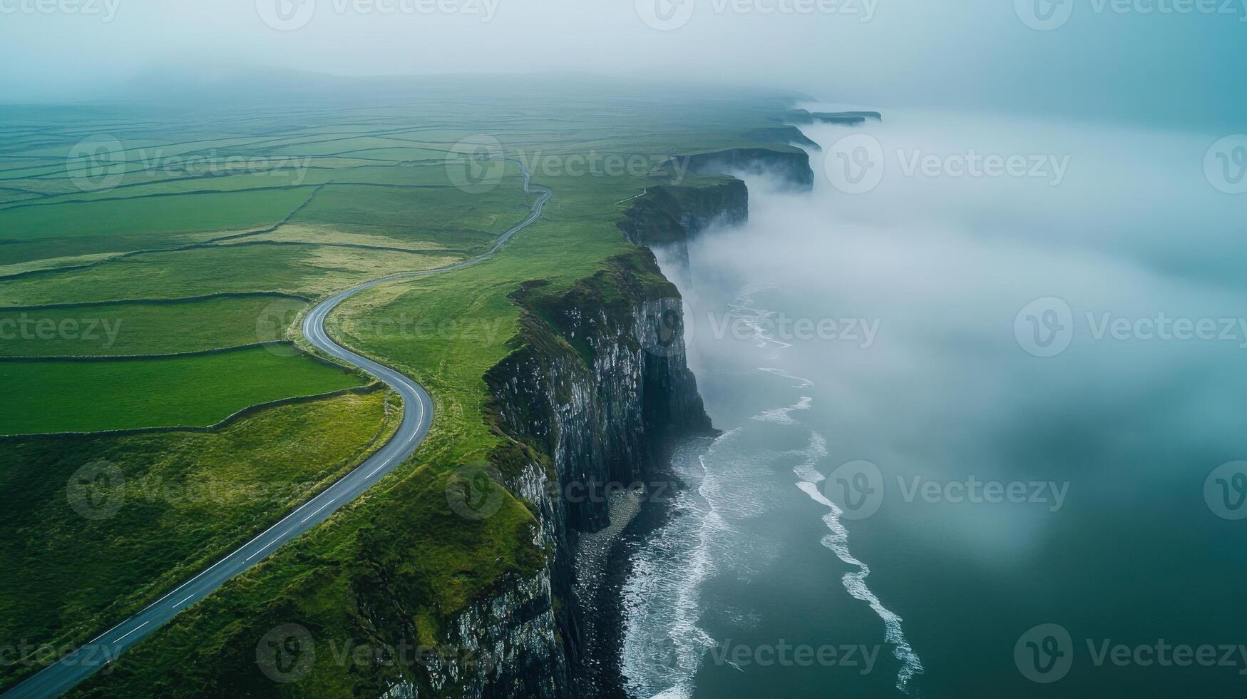 Aerial view of coastal cliffs and foggy ocean in scenic landscape photo