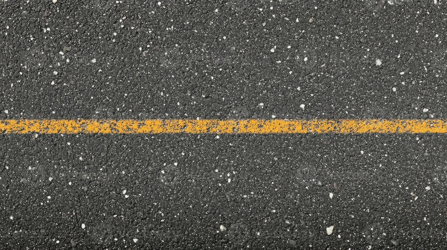 Yellow line on asphalt road surface for transportation concept and infrastructure photo