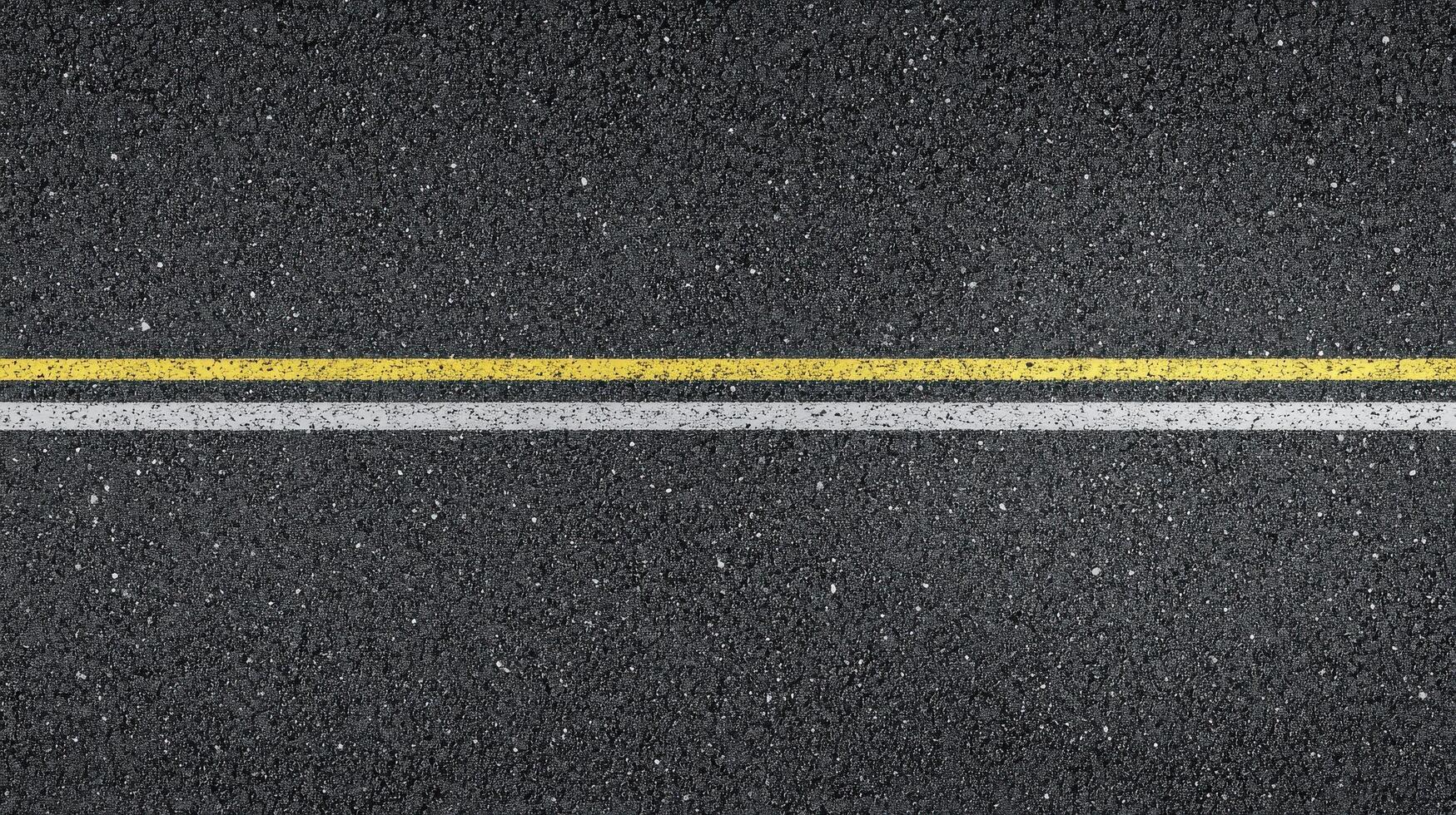Close-up of asphalt road with yellow and white lines for transport concept photo