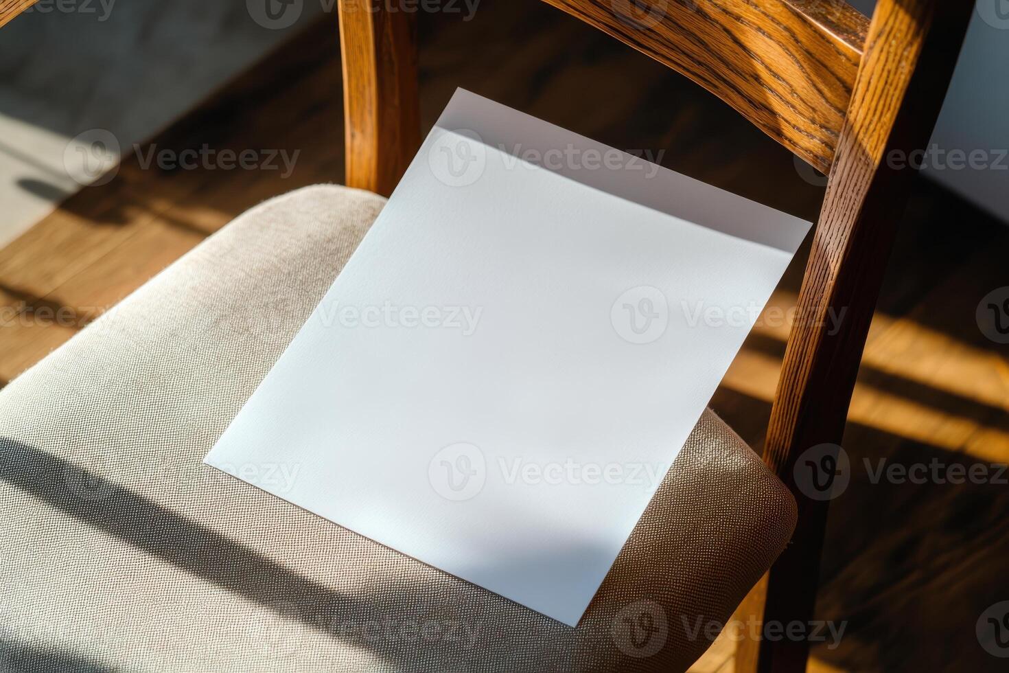 Blank sheet of paper placed on a cushion chair with sunlight streaming through photo