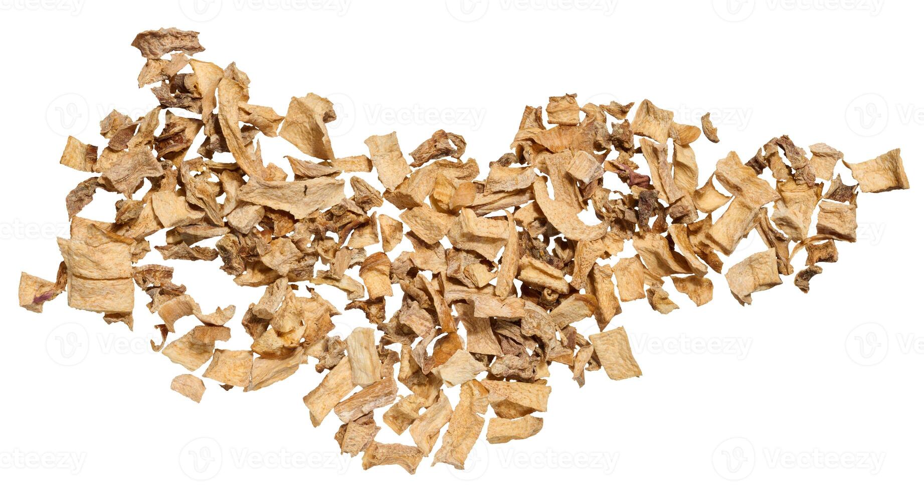 A close-up of dried vegetable pieces, including onion, beetroot, and carrot on isolated background. The mix for soups and seasonings photo