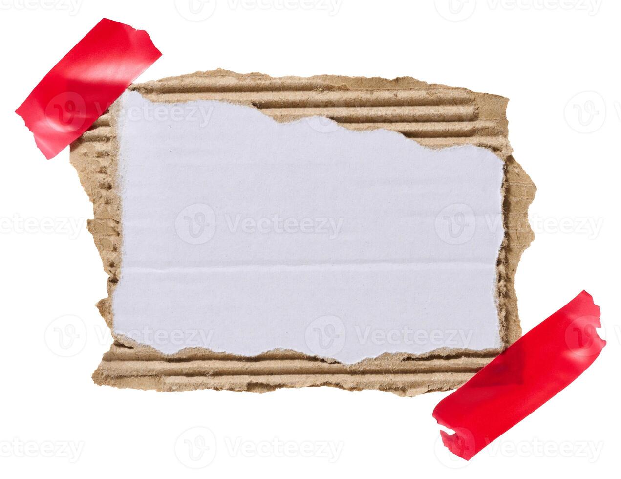 Torn piece of white corrugated cardboard attached to red piece of electrical tape, isolated background. Copy space photo