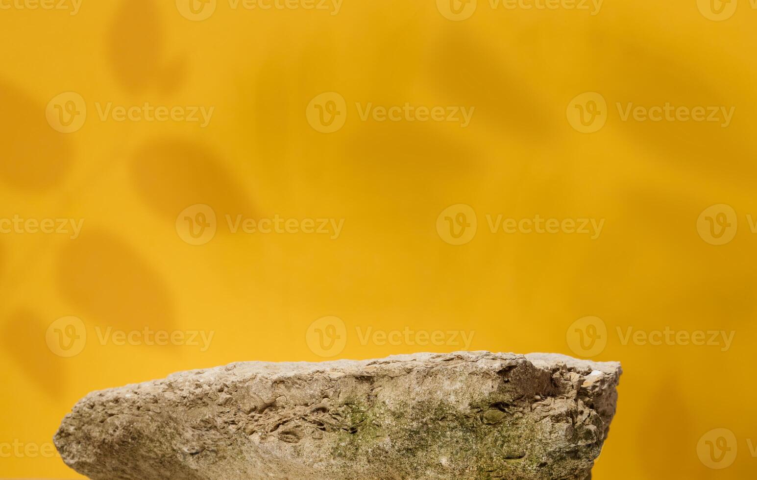 Stones on yellow background, stage for advertising and product demonstration photo