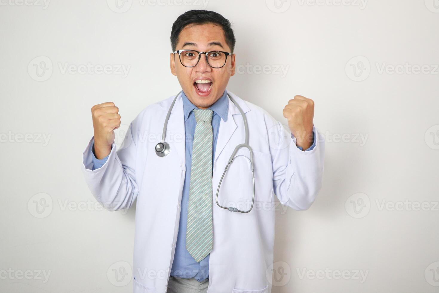 portrait of young asian doctor showing victory pose in hospital photo