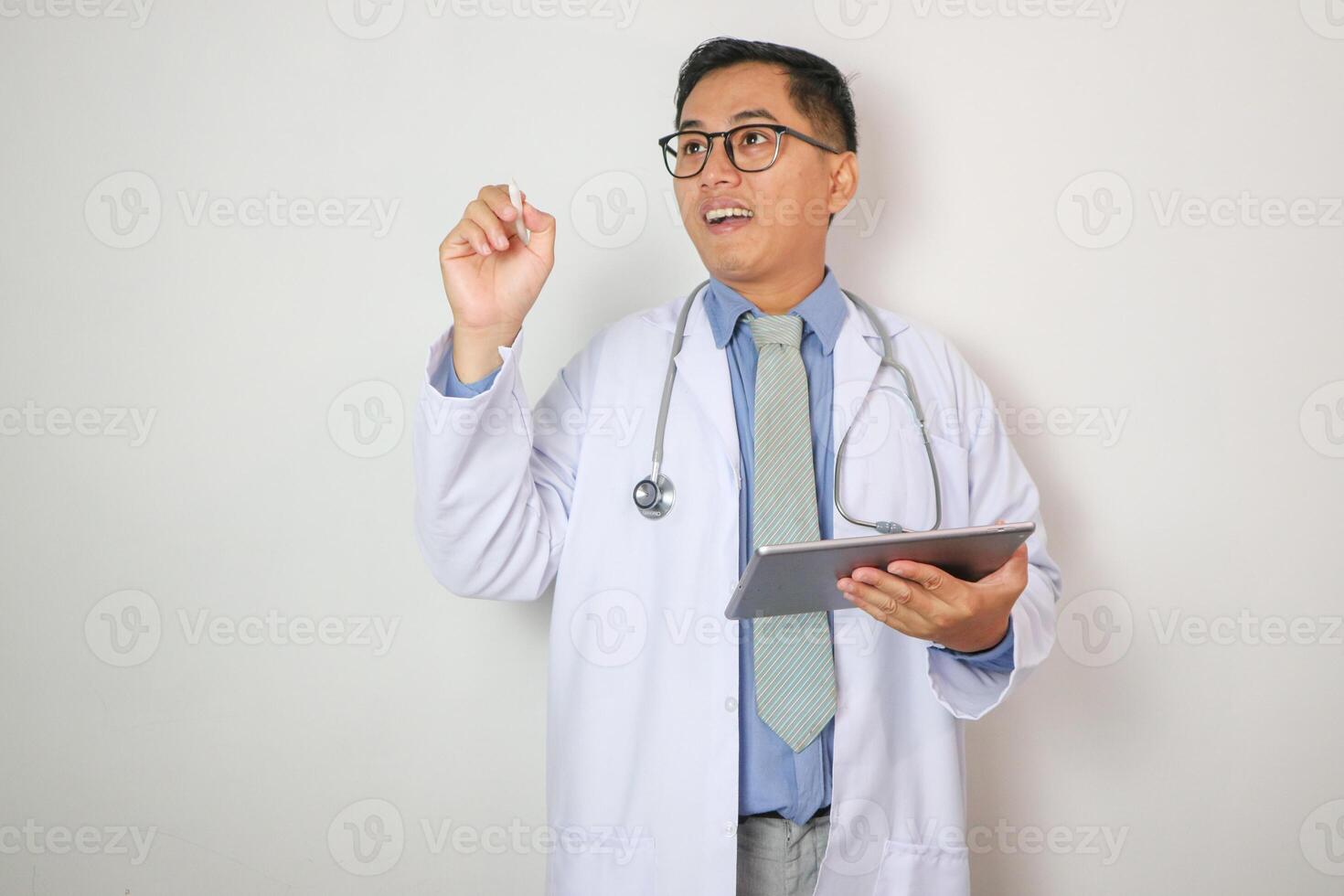 Man portrait of a doctor wearing a white coat and a stethoscope looking into the camera on a white isolated background space photo