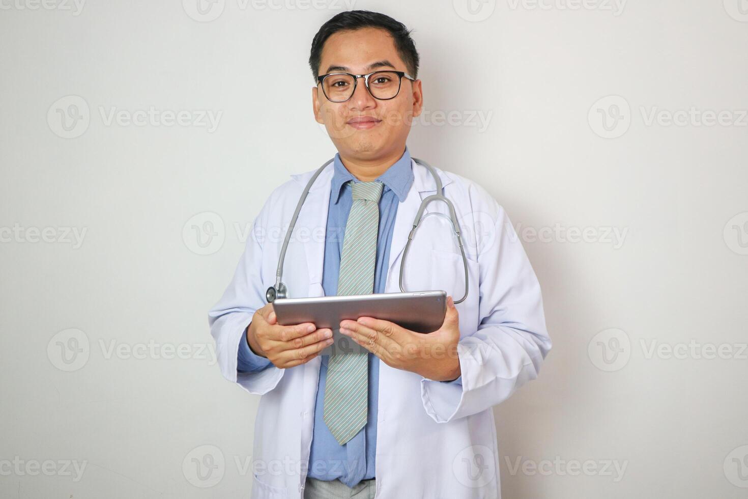Portrait of southeast Asian male medical doctor using digital tablet computer photo