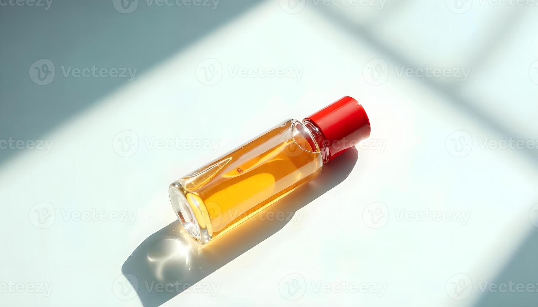Sleek Amber Liquid in a Red-Capped Bottle on a Light Surface photo