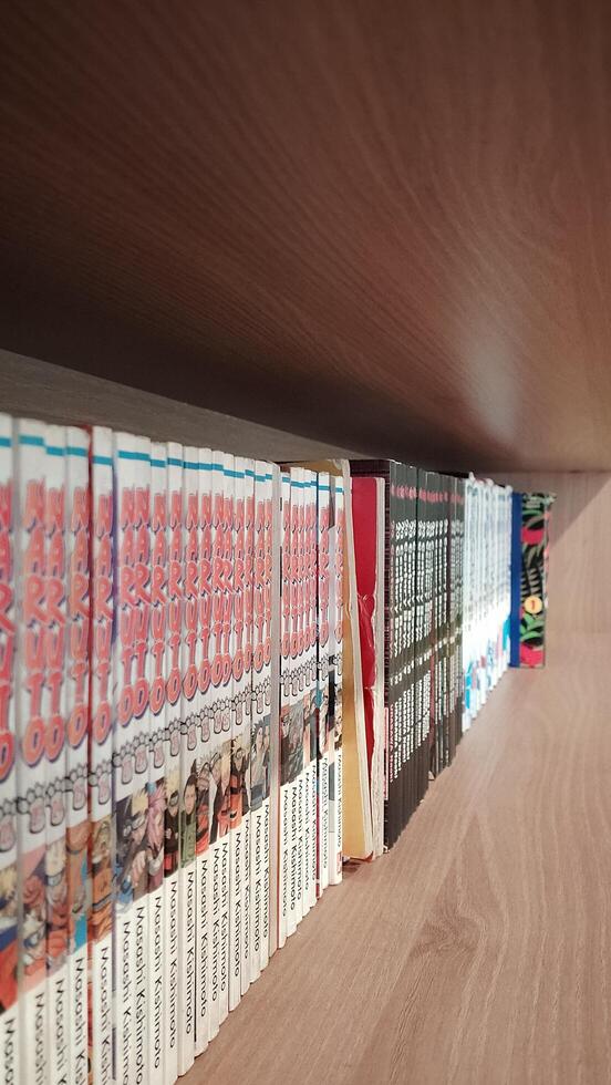 A shelf with a bunch of books on it photo