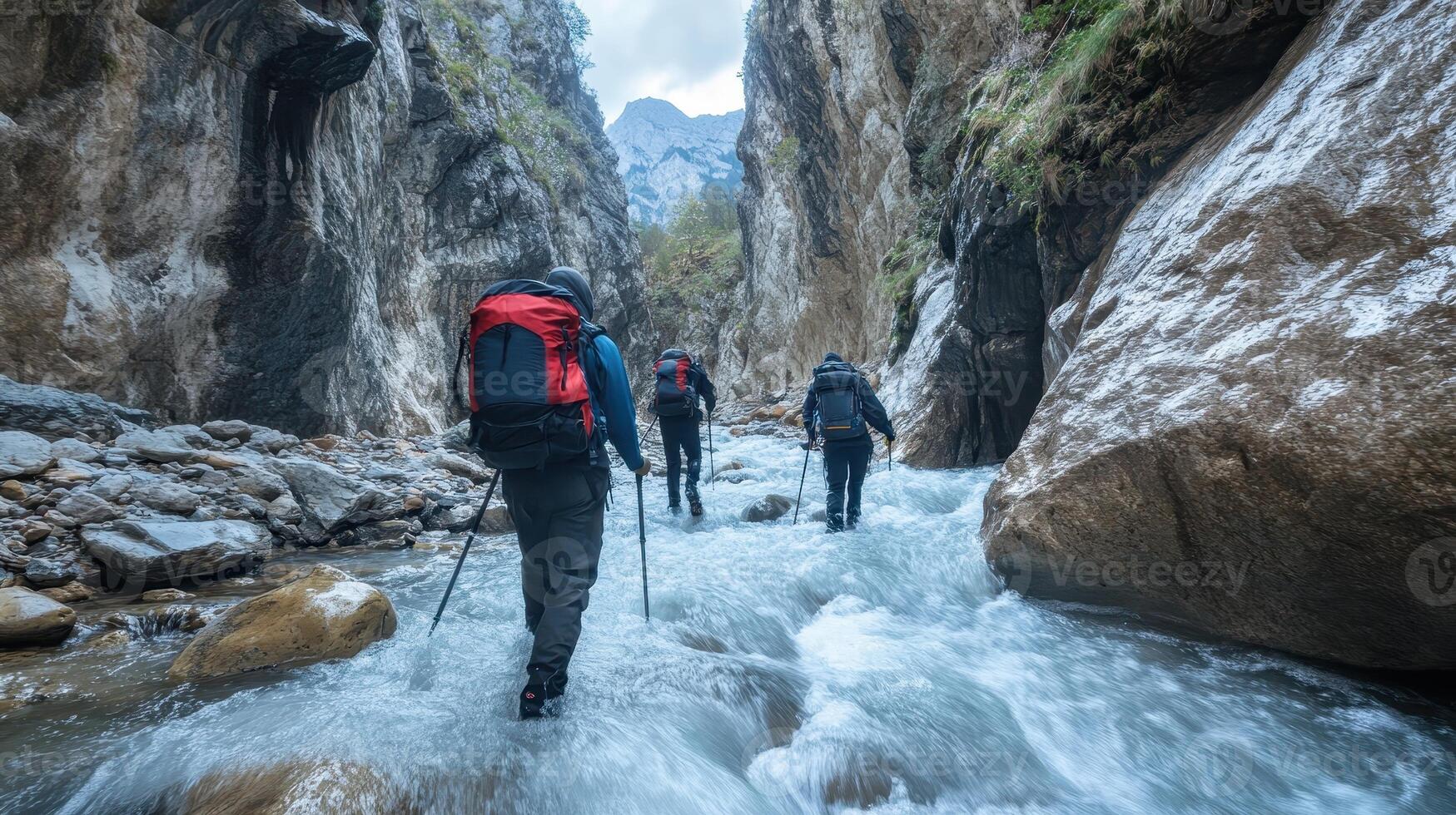 Hikers navigating a river in a narrow canyon, showcasing adventure and nature exploration. photo