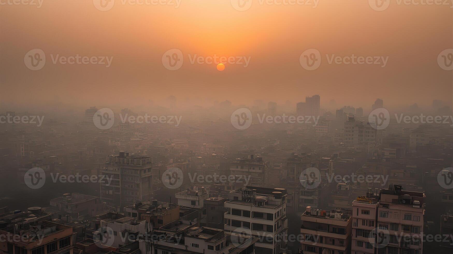 A hazy sunset over a sprawling urban landscape filled with buildings. photo