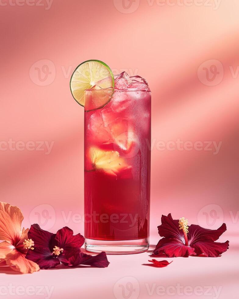 A vibrant cocktail garnished with lime, surrounded by colorful flowers on a soft backdrop. photo
