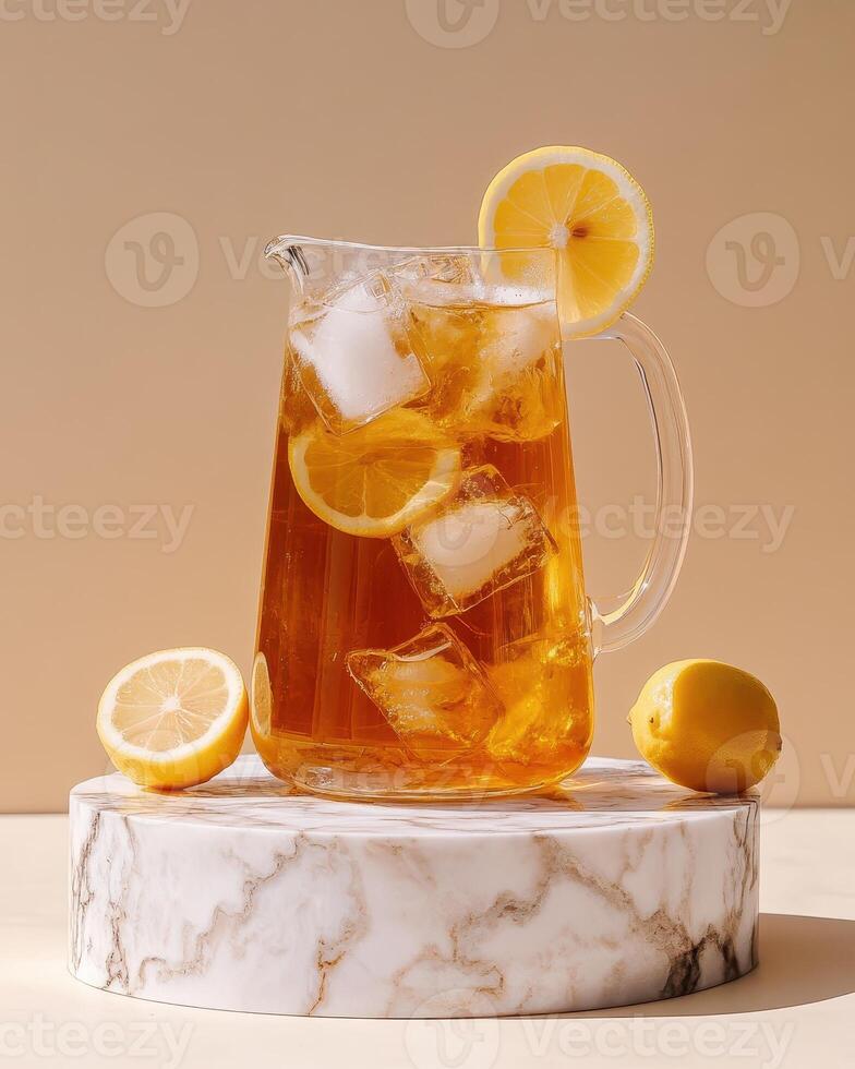 A pitcher of iced tea with lemon slices on a marble stand, perfect for refreshing drinks. photo