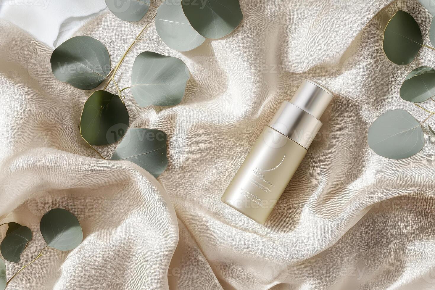 A skincare bottle on soft fabric surrounded by eucalyptus leaves photo