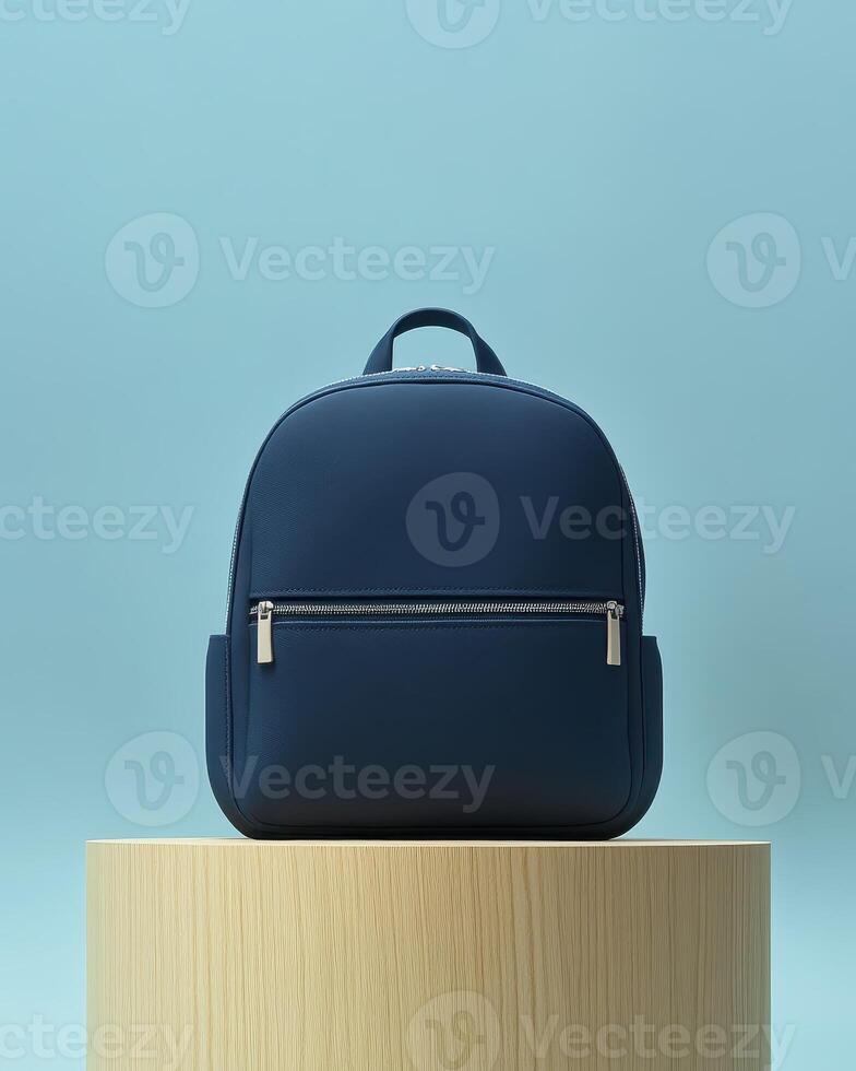 A sleek navy backpack displayed on a wooden pedestal against a soft blue background. photo