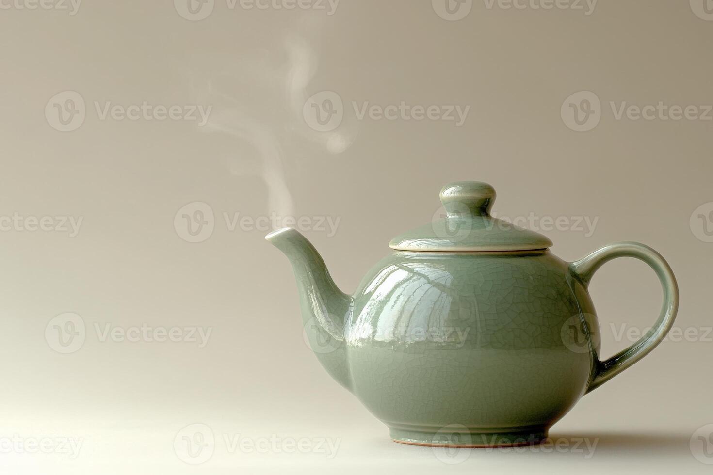 A delicate green teapot sits on a soft surface, with steam gently rising from its spout. The minimalistic backdrop enhances the soothing vibe, inviting warm tea moments. photo