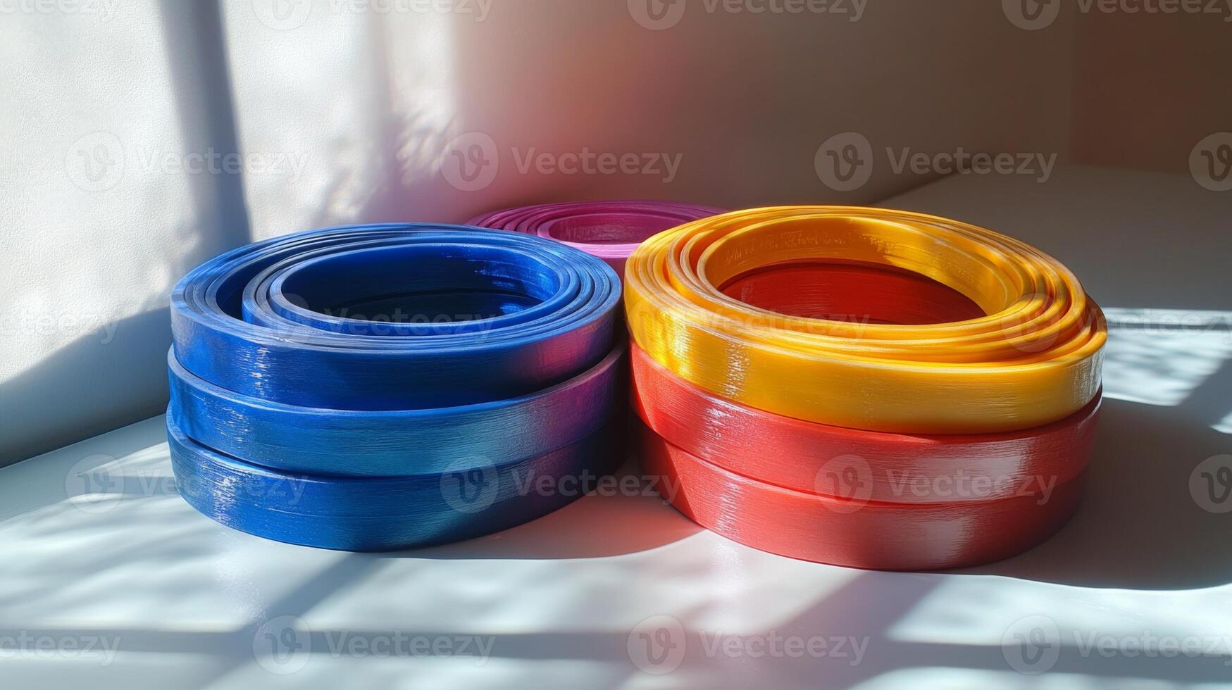 Colorful Stacked Rings on a White Table photo